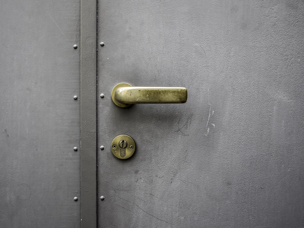 Up-and-over garage door T-handle close-up — garage door lock replacement South London