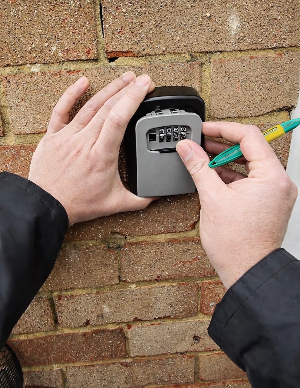 Locksmith setting the combination code on a newly installed key safe
