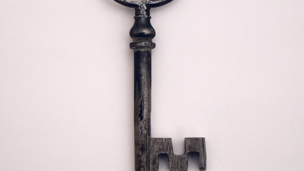 How to choose a door lock UK — key in antique keyhole close-up