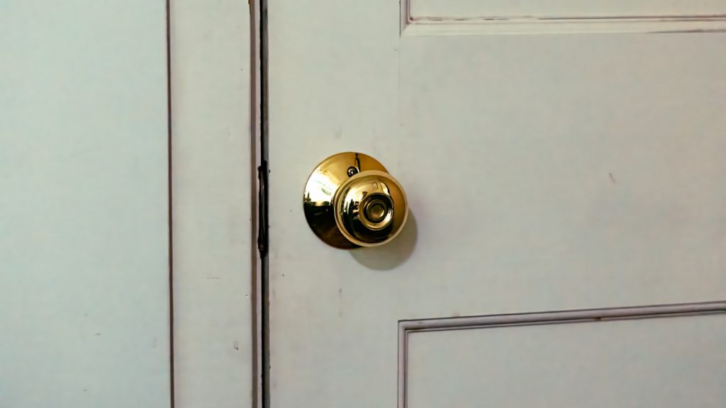 Lock grades explained UK — close-up of a brass door handle and keyway