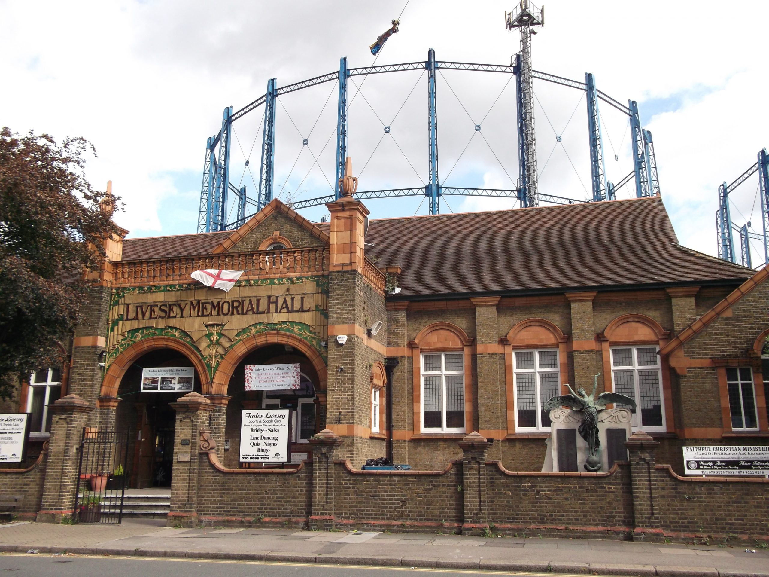 Livesey Memorial Hall Victorian red-brick landmark at Bell Green with gas holders behind, Sydenham SE26
