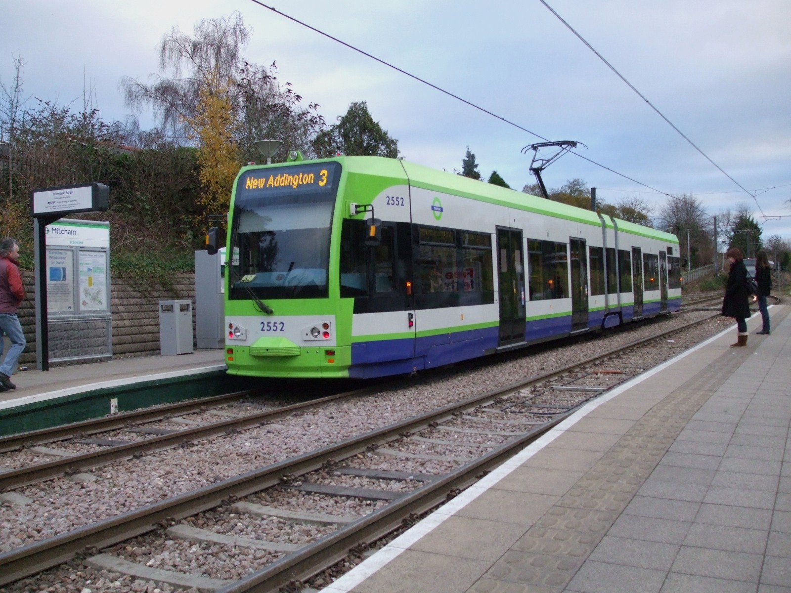 A tram calling at Mitcham tram stop CR4 on the Croydon Tramlink - Locksmith South London